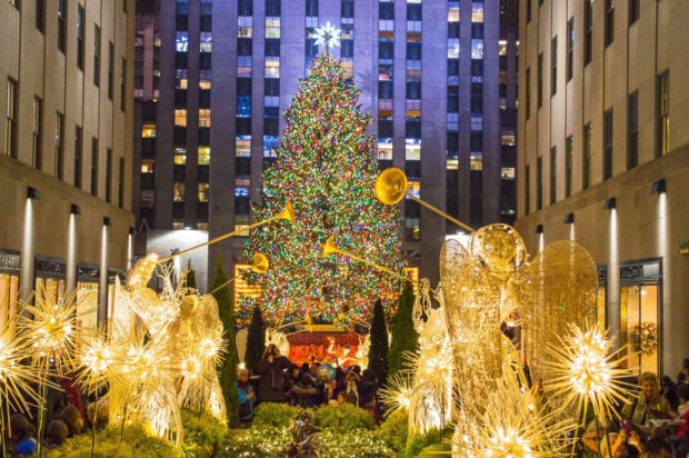New York Christmas scene with illuminated angels and a large decorated tree at Rockefeller Center