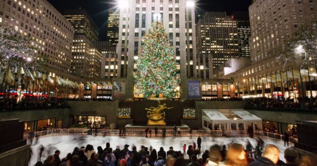 The New York Christmas tree is brightly lit at Rockefeller Center with crowds ice skating below