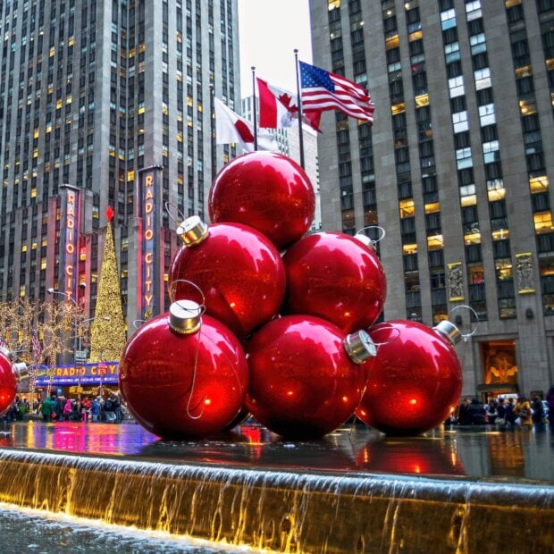 Large red Christmas ornaments stacked in front of Radio City Music Hall in New York