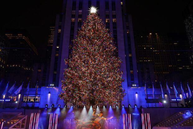 A New York Christmas tree with colorful lights shining at night in the city
