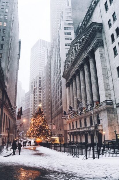 Snow covered New York street with Christmas tree and holiday decorations in winter