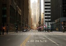 A New York streets view with tall buildings and traffic lights in a busy urban area