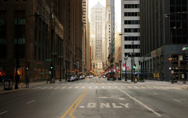 A New York streets view with tall buildings and traffic lights in a busy urban area