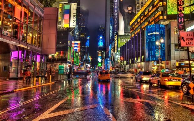 Wet New York Streets at Night with Colorful Neon Lights Reflected on the Road