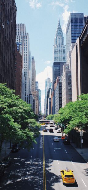 A view of New York Streets with tall buildings and yellow taxi cabs on the road