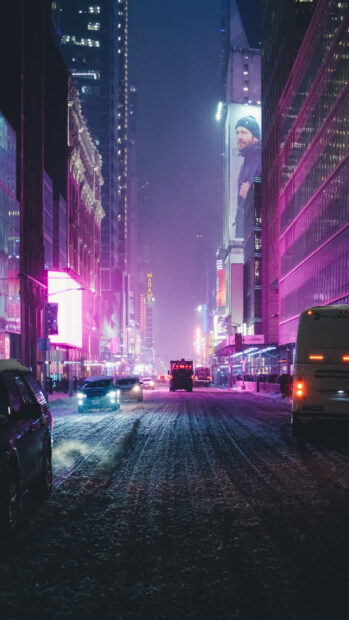 Snowy New York streets at night with cars and bright city lights