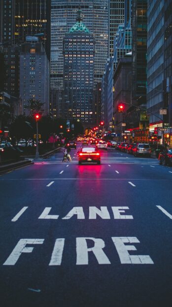 A vibrant New York Streets scene at night with fire lane markings and city buildings illuminated