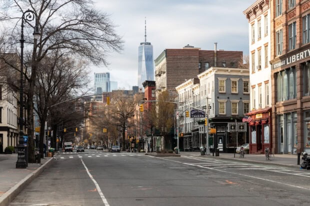 New York streets with old buildings and the Freedom Tower in the background during winter