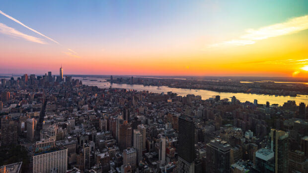 New York city skyline at sunset with vibrant colors and river view