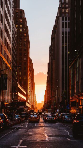New York sunset with city buildings and traffic on a busy street at dusk