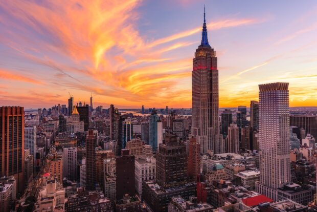 The New York cityscape at sunset with colorful clouds and iconic skyscrapers
