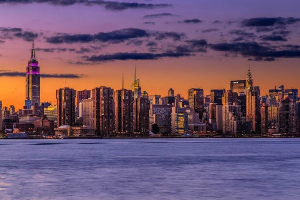New York sunset view with city skyline and glowing buildings at dusk