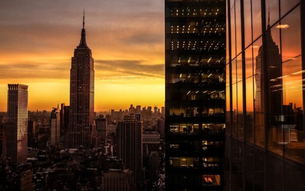 New York sunset view with city skyline and reflective glass buildings at dusk