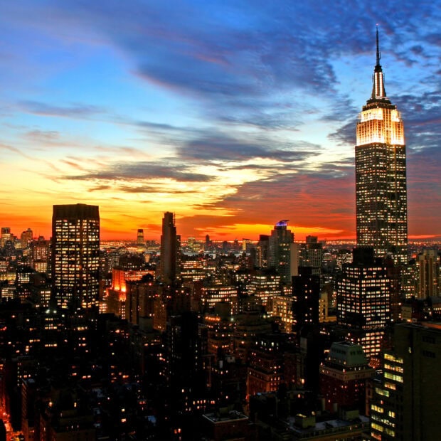 New York sunset with city skyline and illuminated buildings at dusk