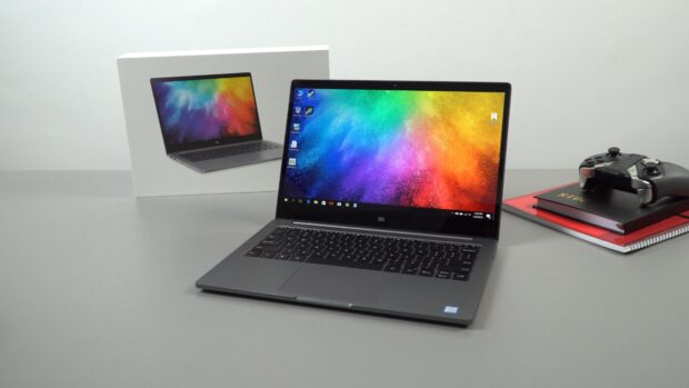 A colorful digital design displayed on a sleek gray notebook keyboard