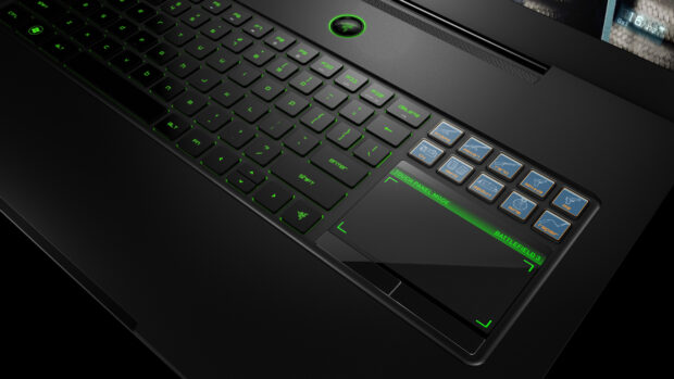 Close up of notebook keyboard with green backlit keys and touch panel mode