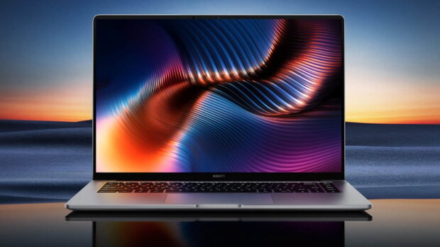 Abstract colorful waves displayed on a notebook screen in a modern setting