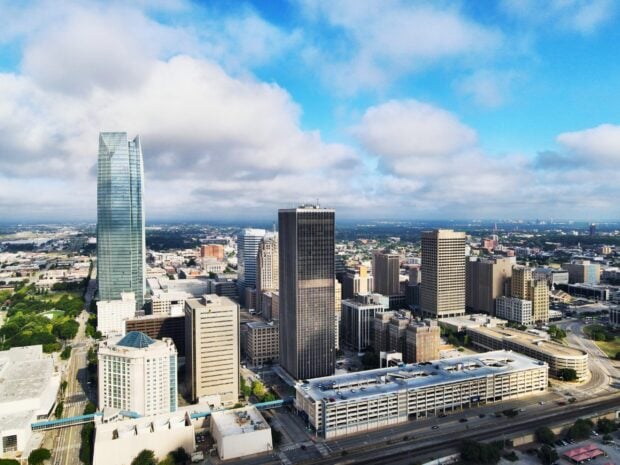 A clear view of Oklahoma City skyline with tall buildings and blue sky