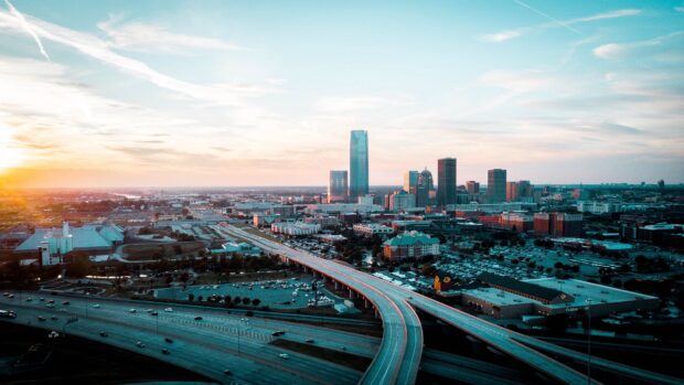 A stunning view of Oklahoma City skyline during sunset featuring the cityscape and highways