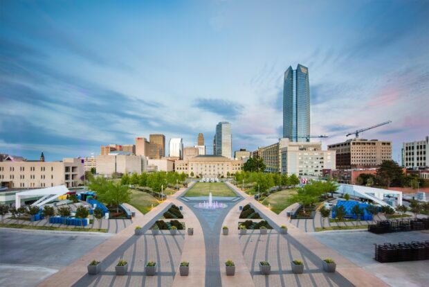 A clear view of Oklahoma City skyline with modern buildings and green park in high definition