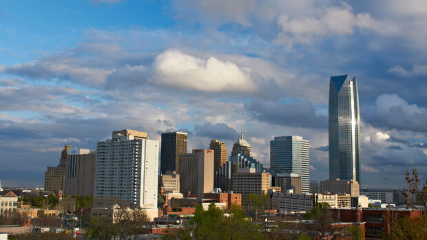 Oklahoma City skyline featuring modern buildings under a dramatic sky