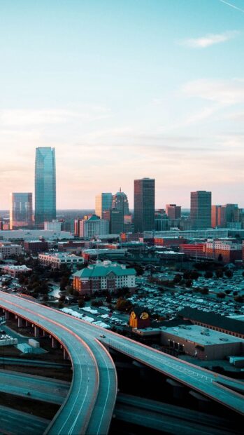 A scenic view of Oklahoma City skyline with highways and buildings under a clear sky