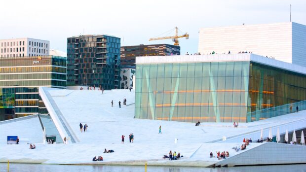 People Enjoying The White Roof Terrace In Oslo Urban Area