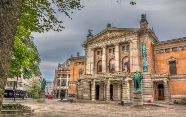 The National Theater statue and architecture in Oslo cityscape