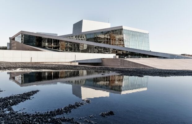 Modern architecture of Oslo reflecting on water at the waterfront