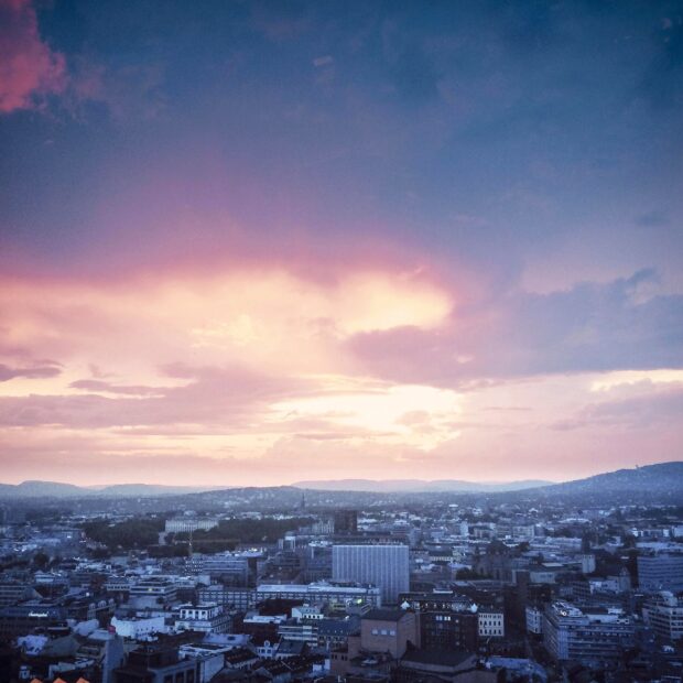 Oslo cityscape under a colorful sunset sky showcasing Oslo scenery