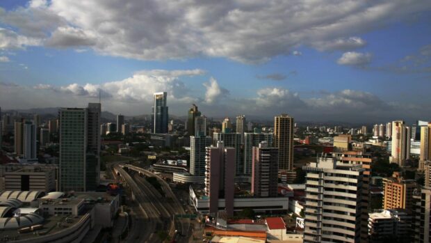 A panoramic view of Panama City with tall buildings and a cloudy sky in high definition