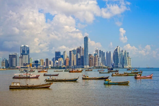 Traditional boats floating on the water in Panama City skyline