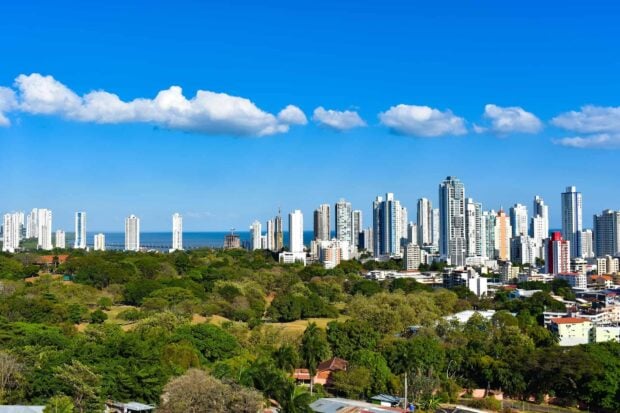 Panorama of Panama City skyline with green park in foreground and clear blue sky