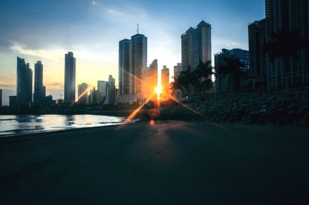 Sunset over Panama City skyline with tall buildings and oceanfront view