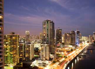 Evening cityscape of Panama City skyline with illuminated buildings and busy roads