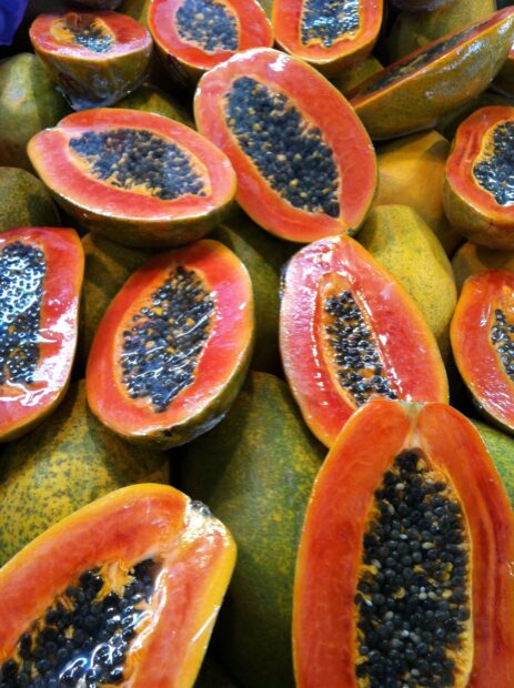 Fresh ripe papaya fruit cut open revealing seeds and vibrant orange flesh