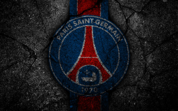 The Paris Saint Germain logo painted on cracked textured ground surface
