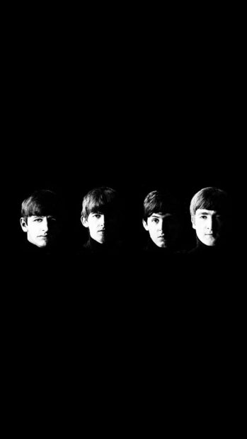 The Beatles members including Paul Mccartney in a black and white portrait against a dark background