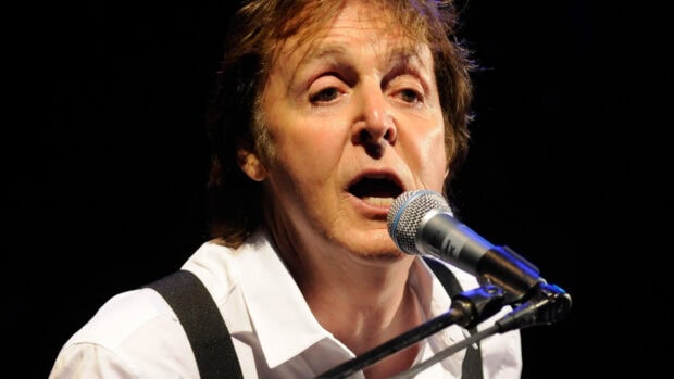 Paul Mccartney singing live on stage during a concert