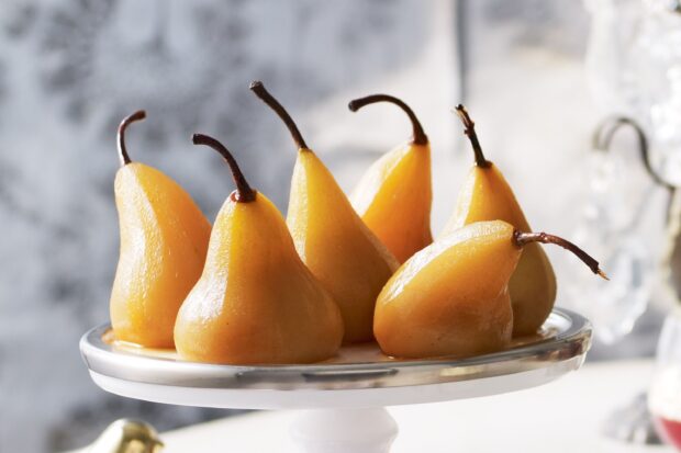 Ripe pear arranged on a white plate ready to serve as a dessert