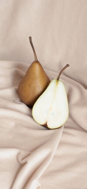 A close up view of fresh pear placed on soft fabric background