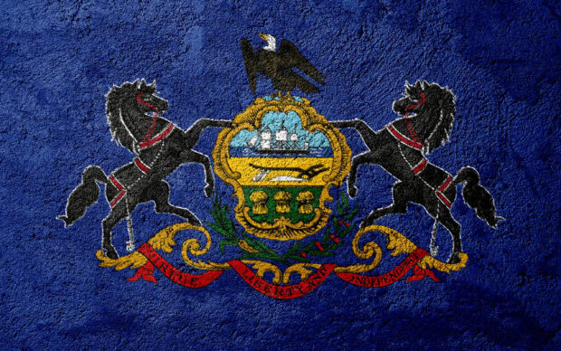 The Pennsylvania state emblem with horses and eagle painted on textured blue wall
