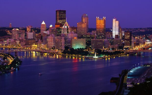Nighttime cityscape of Pittsburgh in Pennsylvania with illuminated skyline and riverfront   Copy