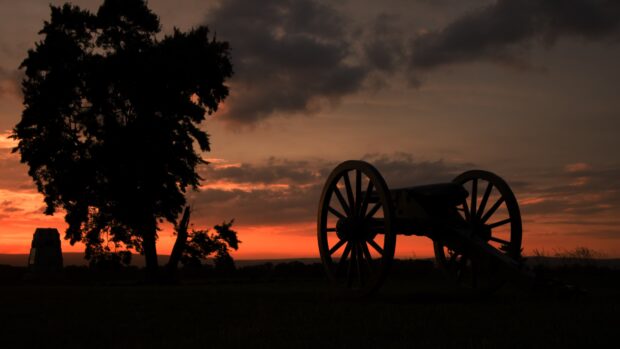 A historical cannon silhouette at sunset with trees in Pennsylvania landscape