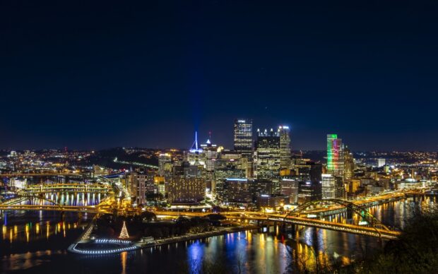Night cityscape of Pittsburgh Pennsylvania with illuminated bridges and skyline