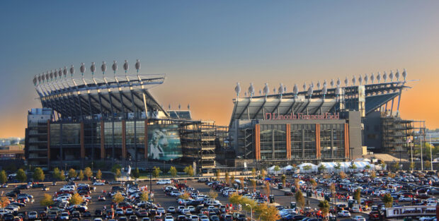 Lincoln Financial Field stadium in Philadelphia Pennsylvania during sunset with a crowded parking lot