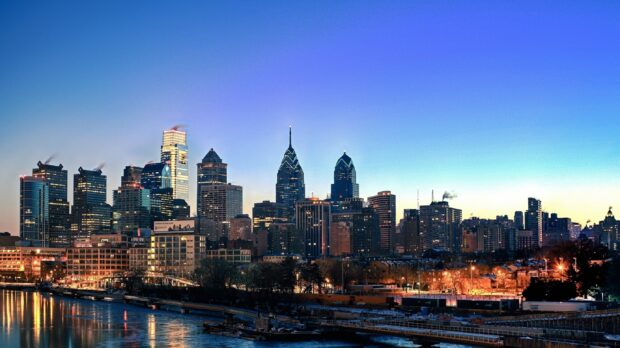 The Philadelphia skyline in Pennsylvania during evening with illuminated buildings and clear sky