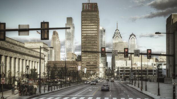 Urban street view with Philadelphia Pennsylvania skyline and traffic lights at sunset