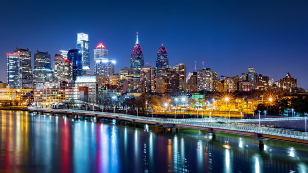 Night cityscape of Philadelphia Pennsylvania reflecting on the river with illuminated skyscrapers and bridges