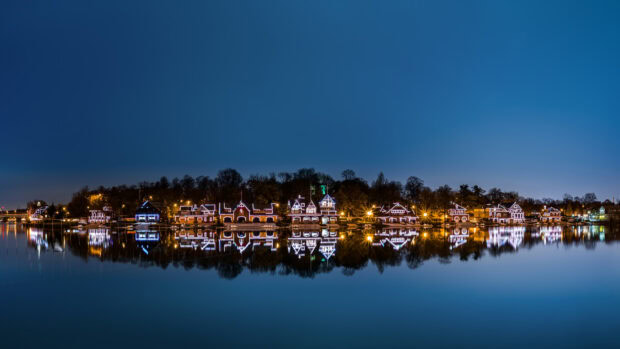 Nighttime view of Philadelphia Pennsylvania with illuminated houses reflecting on calm river water